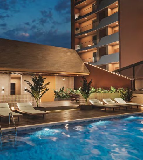 Fern Tellapur swimming pool at dusk with deck seating